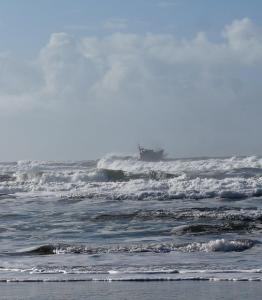 Coast Guard vessel surfing waves